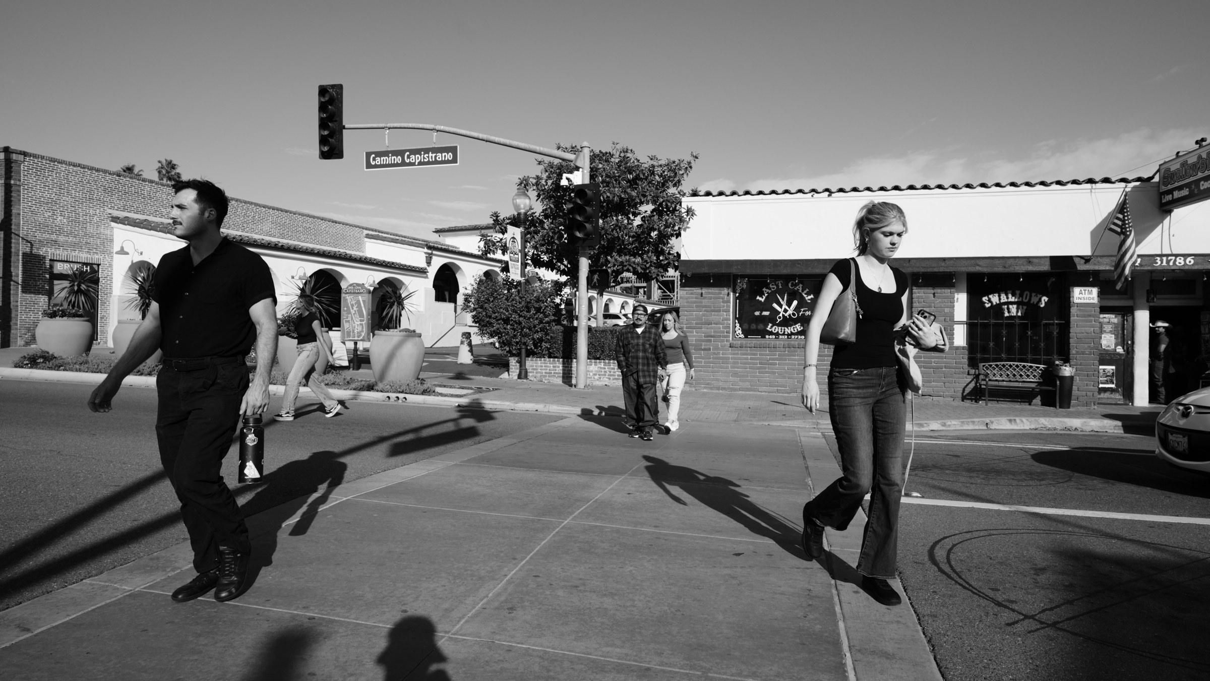 Pedestrians and long shadows at a crossing